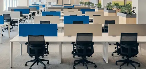 Modern open-plan office space featuring clean workstations, ergonomic chairs, and sanitized carpets provided by professional office cleaning services in Nashville, TN.
